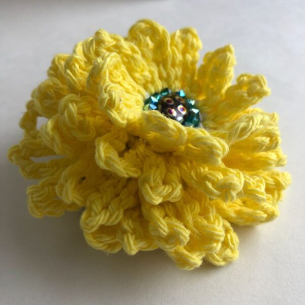 Yellow crocheted flower brooch with beaded centre